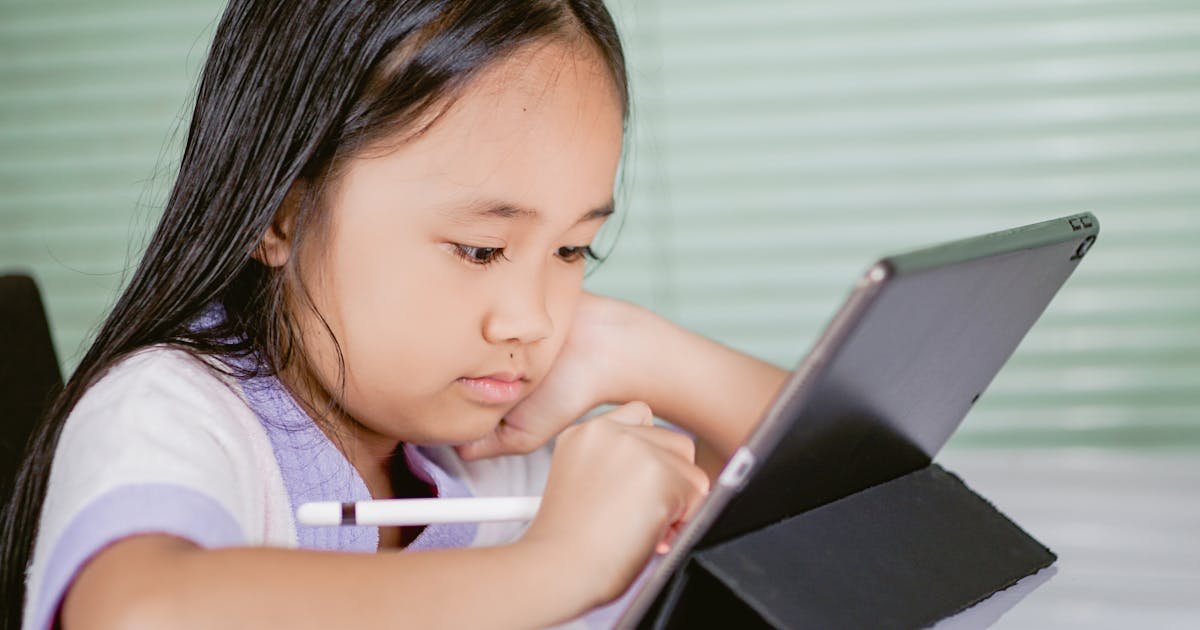 A young girl using a tablet for interactive English learning